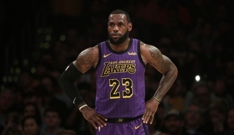 Los Angeles Lakers' LeBron James stands on the court during the first half of an NBA basketball game against the New Orleans Pelicans.