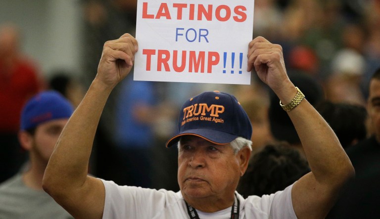 FILE - In this May 25, 2016, file photo, a man holds up a sign for then-Republican presidential candidate Donald Trump before the start of a rally at the Anaheim Convention Center, Wednesday, May 25, 2016, in Anaheim, Calif. Republicans are holding onto a steady share of the Latino vote in the Trump era. With a president who targets immigrants from Latin America, some analysts predicted a Latino backlash against the GOP. But it hasnât happened. Data from APâs VoteCast survey suggests Republicans are holding on to support from Latino evangelicals and veterans.