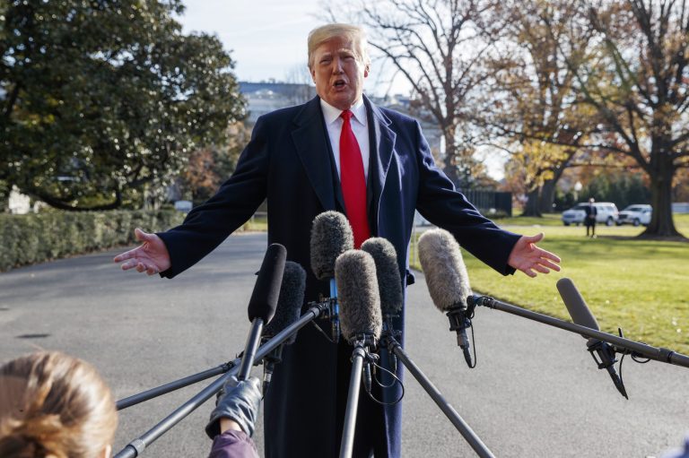 FILE - In this Dec. 7, 2018, file photo, President Donald Trump announces that he is nominating William Barr as his Attorney General, on the South Lawn of the White House, in Washington. Barr, once questioned the effectiveness of a border wall similar to the one the president now wants to construct. Barr was attorney general under President George H.W. Bush when he was asked in a 1992 interview if he supported a proposal from Republican challenger Pat Buchanan to erect a barrier of ditches and fences along the Mexican border to stem the flow of illegal immigrants. Barr described a side-to-side barrier as âoverkill.â