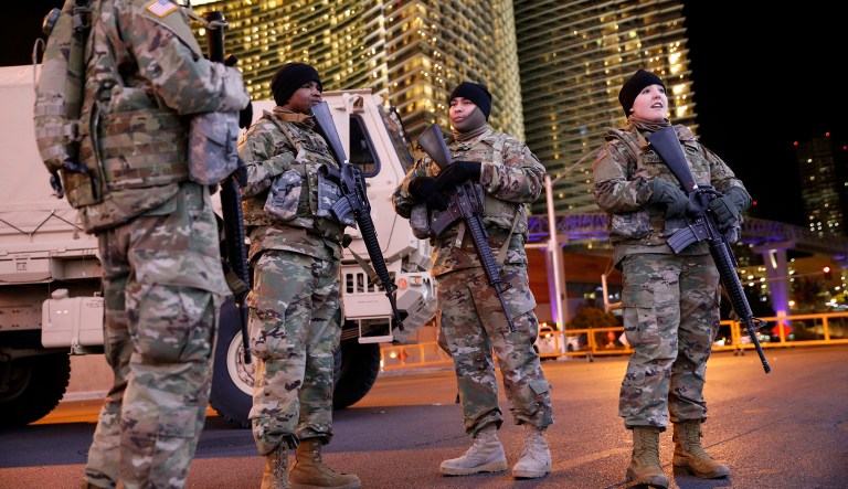 Members of the Nevada National Guard stand at a roadblock on a road leading to the Las Vegas Strip during a New Year's celebration, Monday, Dec. 31, 2018, in Las Vegas.