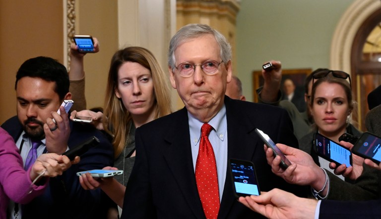 Senate Majority Leader Mitch McConnell of Kentucky, center, talks with reporters as he walks on Capitol Hill in Washington, Wednesday, Jan. 2, 2019, after returning from a meeting with President Trump at the White House.