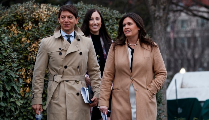 White House press secretary Sarah Huckabee Sanders walks with deputy press secretary Hogan Gidley to speak with reporters about the government shutdown outside the White House, Friday, Jan. 4, 2019, in Washington. 