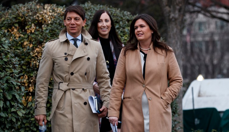 White House press secretary Sarah Huckabee Sanders walks with deputy press secretary Hogan Gidley to speak with reporters about the government shutdown outside the White House, Friday, Jan. 4, 2019, in Washington. 