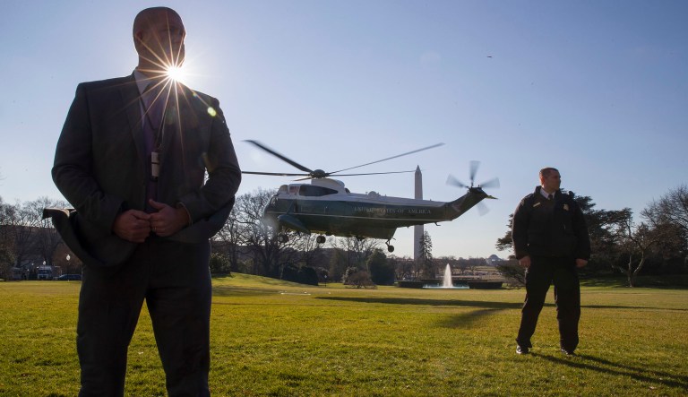Officers with the U.S. Secret Service stand as Marine One, with President Donald Trump aboard, depart from the South Lawn of the White House, Sunday, Jan. 6, 2019, in Washington. Trump is en route to Camp David.