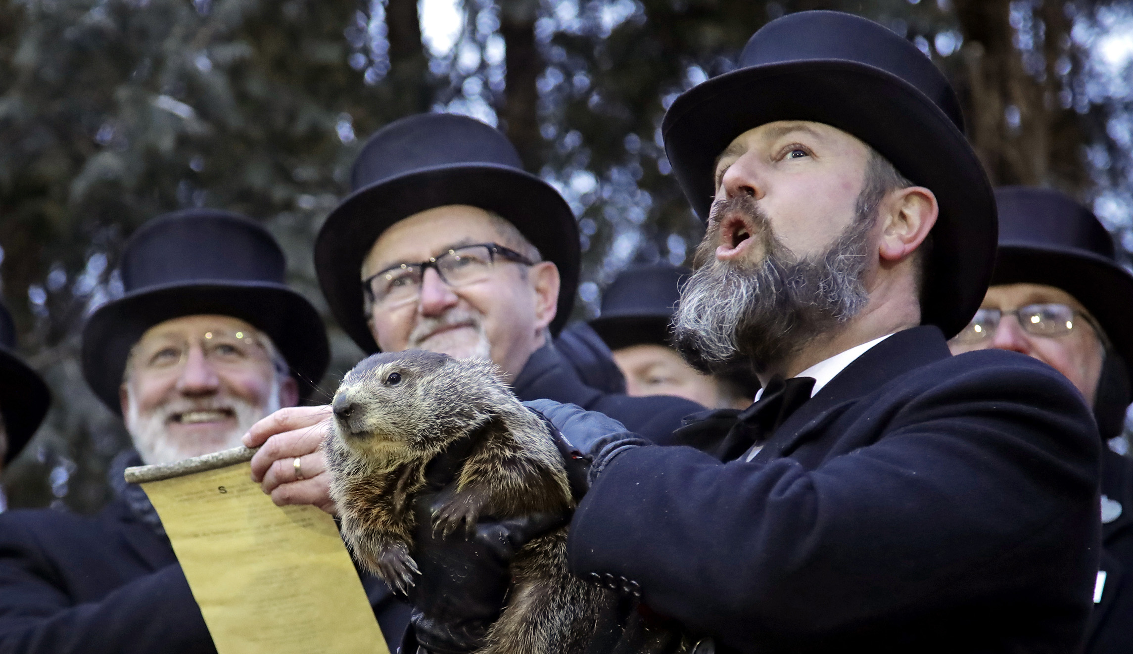Groundhog Club co-handler Al Dereume, right, holds Punxsutawney Phil, the weather prognosticating groundhog, during the 133rd celebration of Groundhog Day on Gobbler's Knob in Punxsutawney, Pa., on Saturday.
