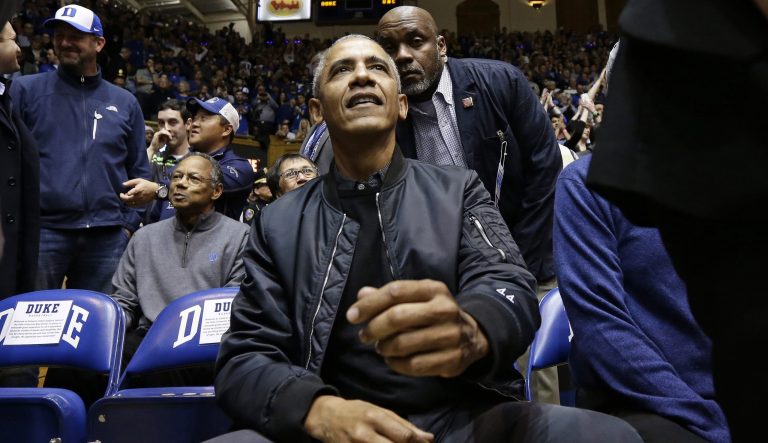 Former President Barack Obama joins fans during an NCAA college basketball game between Duke and North Carolina in Durham, N.C., Wednesday, Feb. 20, 2019. 