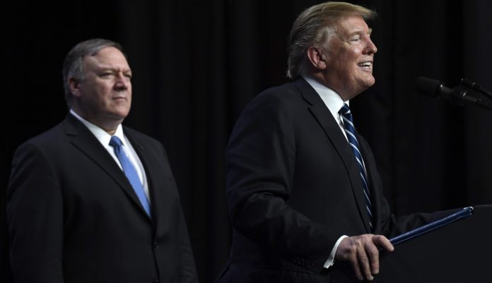 President Donald Trump, right, standing with Secretary of State Mike Pompeo, left, speaks during a news conference in Hanoi, Vietnam, Thursday, Feb. 28, 2019.