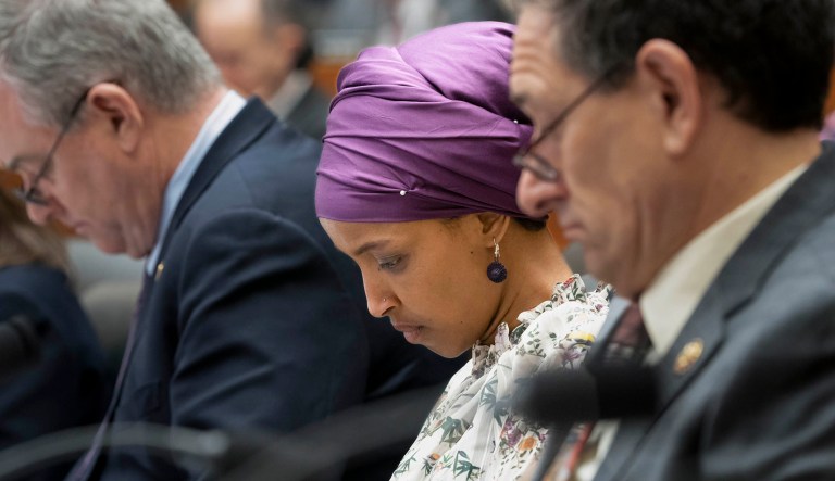 Rep. Ilhan Omar, D-Minn., sits with fellow Democrats, Rep. David Trone, D-Md., left, and Rep. Andy Levin, D-Mich., right, on the House Education and Labor Committee in D.C.