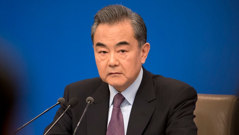 Chinese Foreign Minister Wang Yi listens to a journalist's question during a press conference.