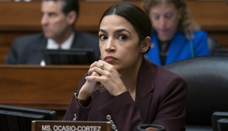 In this Feb. 27, 2019 photo, Rep. Alexandria Ocasio-Cortez, D-N.Y., listens to questioning of Michael Cohen on Capitol Hill in Washington. 