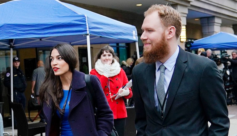 Rep. Alexandria Ocasio-Cortez, D-N.Y., left, is seen. Walking alongside Ocasio-Cortez is Riley Roberts.