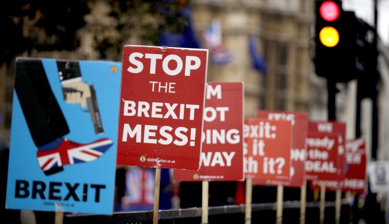 Placards placed by anti-Brexit supporters stand opposite the Houses of Parliament in London, Monday, March 18, 2019. 