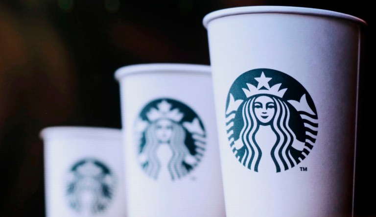 An image of Starbucks cups is seen at the company's annual shareholders meeting in Seattle. 