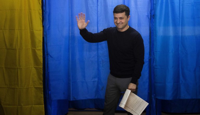 Ukrainian comedian and presidential candidate Volodymyr Zelenskiy waves to the media before casting his ballot at a polling station, during the presidential elections in Kiev, Ukraine, Sunday, March. 31, 2019. 