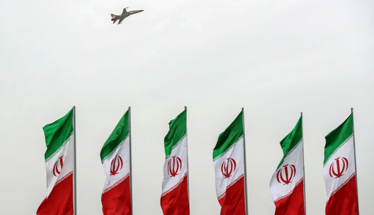 A fighter jet flies over Iranian flags during the army parade commemorating National Army Day in front of the shrine of the late revolutionary founder Ayatollah Khomeini, just outside Tehran, Iran.