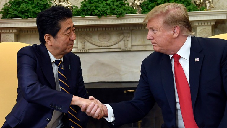 President Trump, right, shakes hands with Japanese Prime Minister Shinzo Abe, left, in the Oval Office of the White House in Washington.