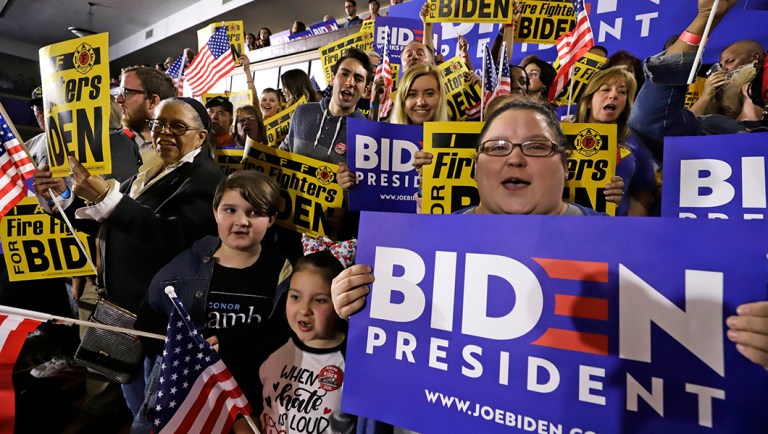 People listen to former vice president and Democratic presidential candidate Joe Biden.