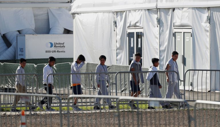 In this Feb. 19, 2019  photo, youngsters line up to enter a tent at the Homestead Temporary Shelter for Unaccompanied Children in Homestead, Fla. 