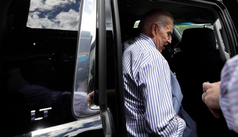 A reporter asks one last question as former vice president and Democratic presidential candidate Joe Biden gets into his vehicle after a campaign event in Berlin, N.H. 
