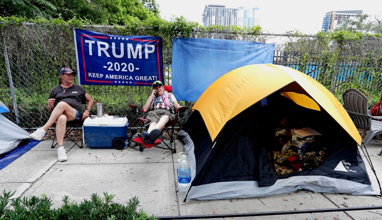Anna Connelly, left, and Jeanna Gullett, supporters of President Trump, make camp Monday, June 17, 2019, in Orlando, Fla. as they wait to attend a rally for the president on Tuesday evening. 
