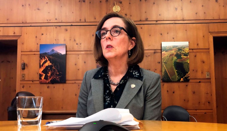 Oregon Gov. Kate Brown speaks with the media at the Capitol in Salem, Oregon.