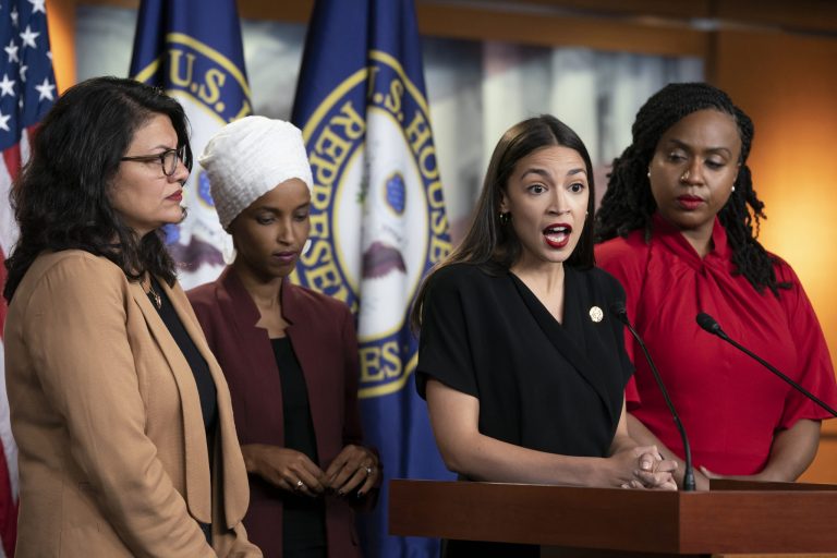 Rep. Alexandria Ocasio-Cortez, D-N.Y., speaks as, from left, Rep. Rashida Tlaib, D-Mich., Rep. Ilhan Omar, D-Minn., and Rep. Ayanna Pressley, D-Mass.