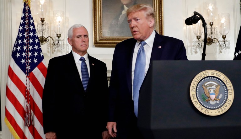 President Trump walks away after speaking about the mass shootings in El Paso, Texas and Dayton, Ohio, in the Diplomatic Reception Room of the White House on Monday in Washington. Vice President Mike Pence stands at the left. 