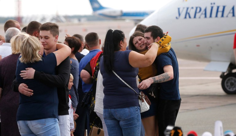 Relatives of Ukrainian prisoners freed by Russia greet them upon their arrival at Boryspil airport, outside Kyiv, Ukraine, Saturday.