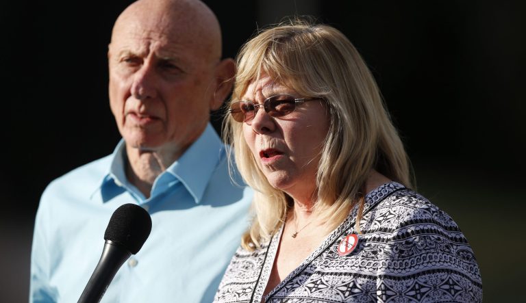 In this July 16, 2015 photo, Sandy Phillips, right, who lost her 24-year-old daughter Jessica Ghawi in the 2012 Aurora, Coloorado, theater massacre, responds to questions with her husband, Lonnie.