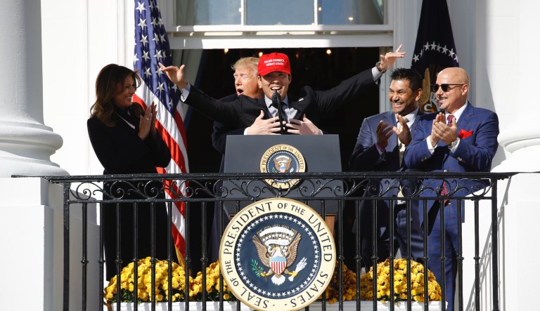 President Donald Trump hugs Washington Nationals catcher Kurt Suzuki, during an event to honor the 2019 World Series champion Washington Nationals on the balcony of the White House, Monday, Nov. 4, 2019, in Washington.