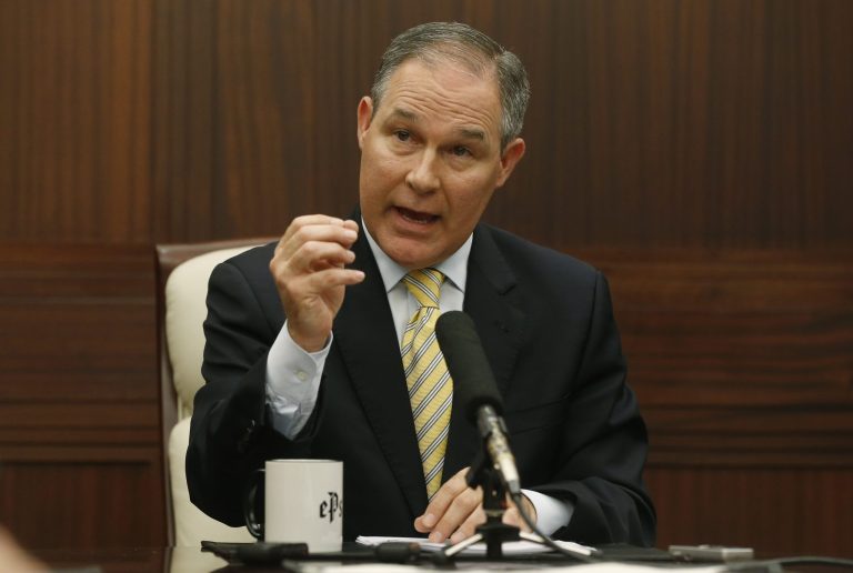 In this Thursday, June 13, 2013 photo, Oklahoma Attorney General Scott Pruitt gestures as he answers a question during a news conference in Oklahoma City. The Oklahoma attorney general is defending his work with energy companies and denying that he participated in a "secretive alliance" with them. Over the weekend, The New York Times reported that Pruitt was among other attorneys general working with energy producers in pushing back against federal attempts to regulate the oil and gas industry.
