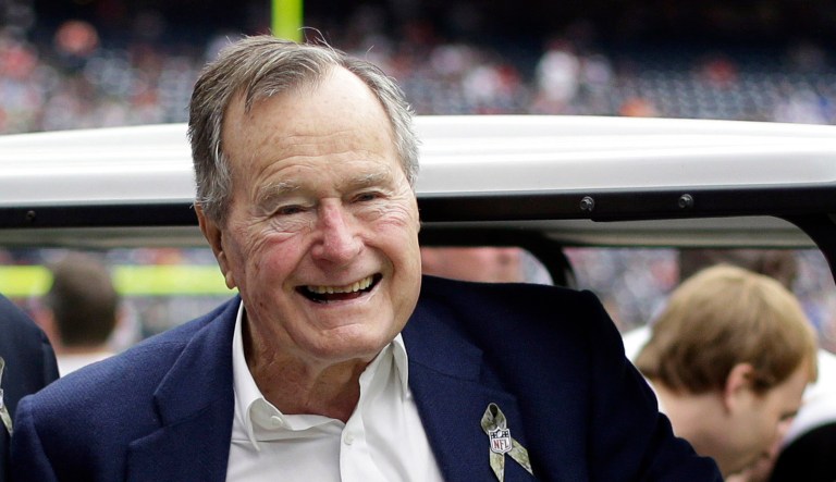Former president George H.W. Bush pauses for a photo before an NFL football game in Houston between the Buffalo Bills and the Houston Texans.