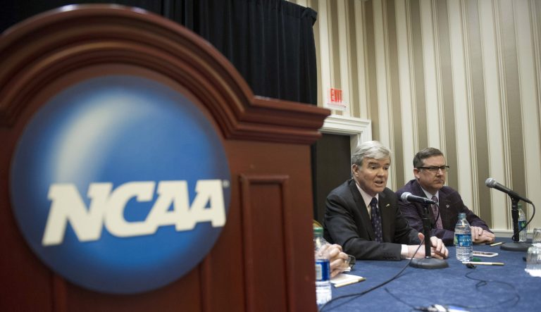 NCAA President Mark Emmert, left, and Division 1 board of directors member Kirk Schulz, Kansas State University president, speak with reporters during a news conference at the NCAA Convention in Oxon Hill, Md., Friday, Jan. 16, 2015. 