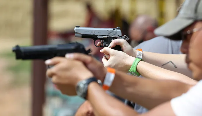 In this July 20, 2014 photo, shooters practice with pistols at the gun range at Dragonman's, a gun dealer east of Colorado Springs, Colo.