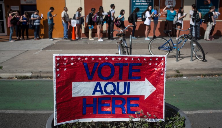 Voters wait in line to cast their ballots at a polling station located at the University Co-op in Austin, Texas, on Tuesday, March 1, 2016.