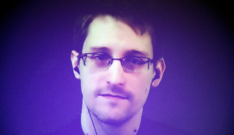 Former U.S. National Security Agency contractor Edward Snowden, who is in Moscow, is seen on a giant screen during a live video conference for an interview as part of Amnesty International's annual Write for Rights campaign at the Gaite Lyrique in Paris, France, Dec. 10, 2014. 