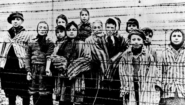 This file picture taken just after the liberation by the Soviet army in January, 1945, shows a group of children wearing concentration camp uniforms.