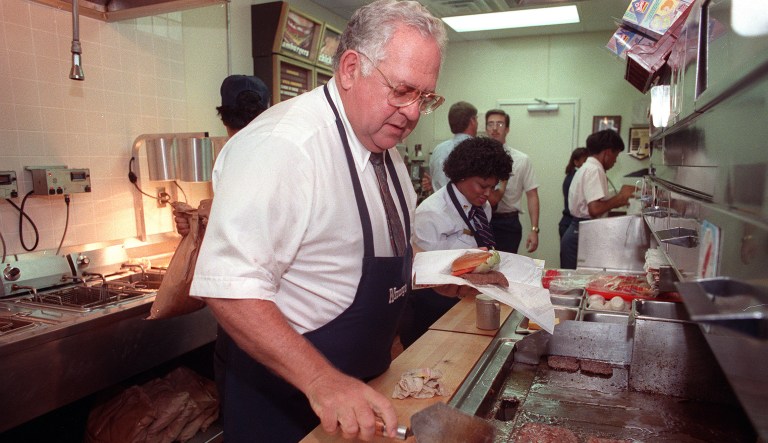 Dave Thomas, Wendy's restaurant founder and senior chairman of the board for Wendy's International Inc., flips hamburgers at one of the company's eateries in downtown Atlanta, Ga., Wednesday, July 19, 1989.