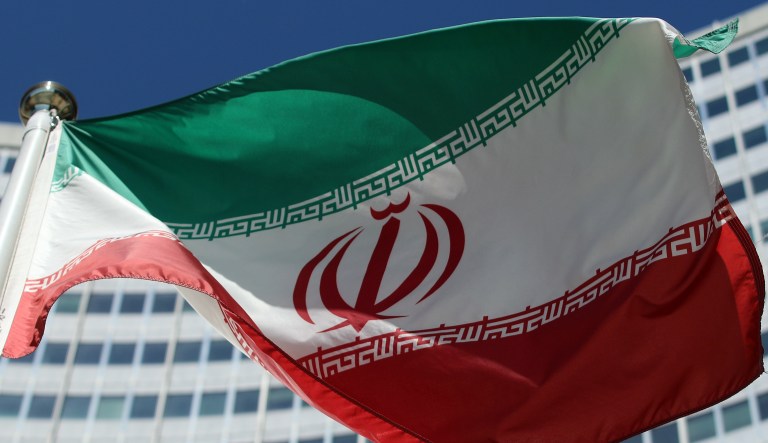 The Iranian flag flies in front of a U.N. building where closed-door nuclear talks take place at the International Center in Vienna, Austria, Friday, July 4, 2014.