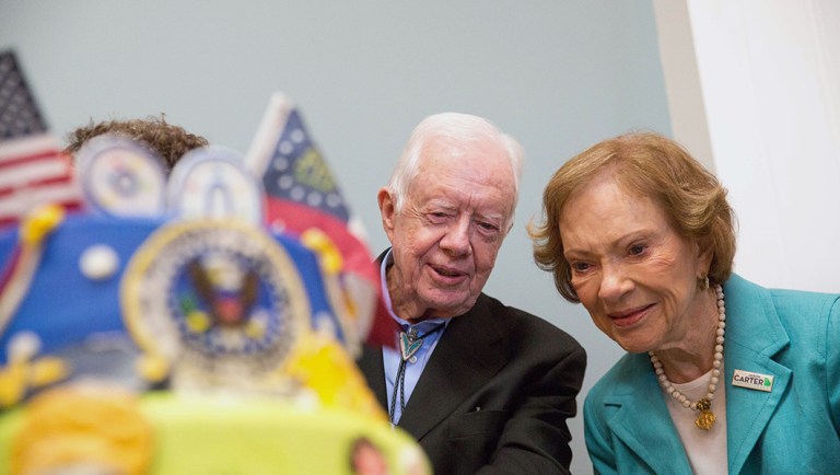 Former President Jimmy Carter, left, and former first lady Rosalynn Carter look at a birthday cake during Jimmy Carter's 90th birthday celebration held at Georgia Southwestern University, Saturday, Oct. 4, 2014, in Americus, Ga. 