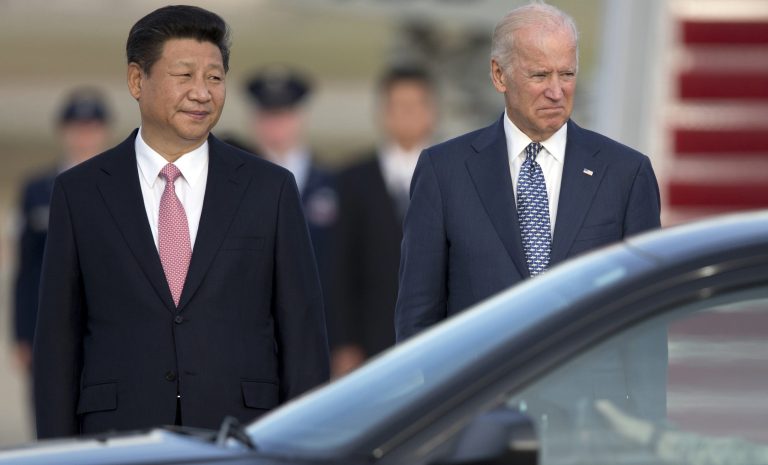 Chinese President Xi Jinping and former Vice President Joe Biden stand together as President Xi Jinping prepares to board a motorcade during an arrival ceremony at Andrews Air Force Base, Md., Thursday, Sept. 24, 2015. 