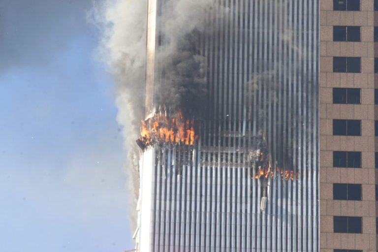 Debris fall from one of the burning twin towers of the World Trade Center after a hijacked plane crashed into the tower on September 11, 2001 in New York City.