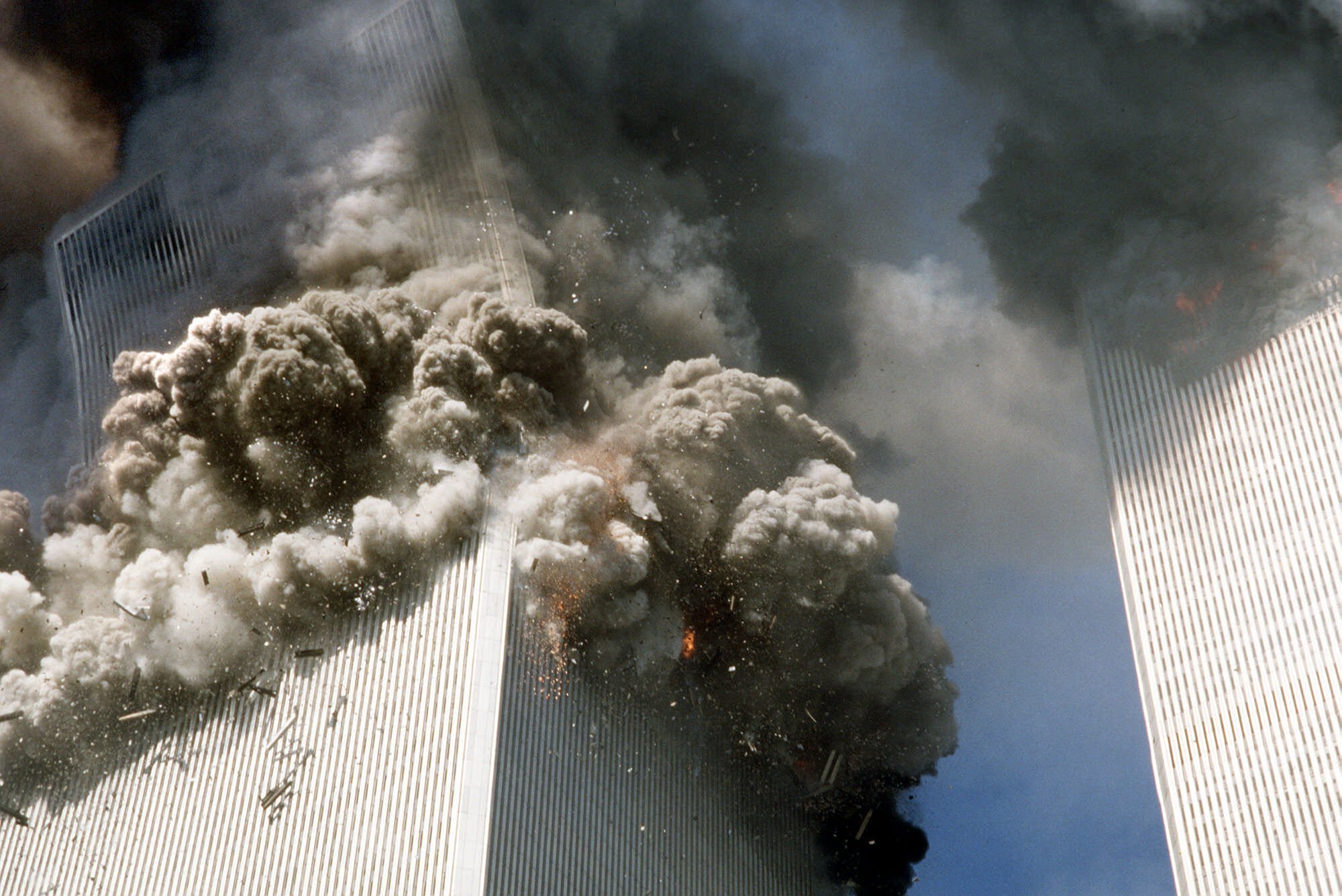 The south tower of the World Trade Center, left, begins to collapse.