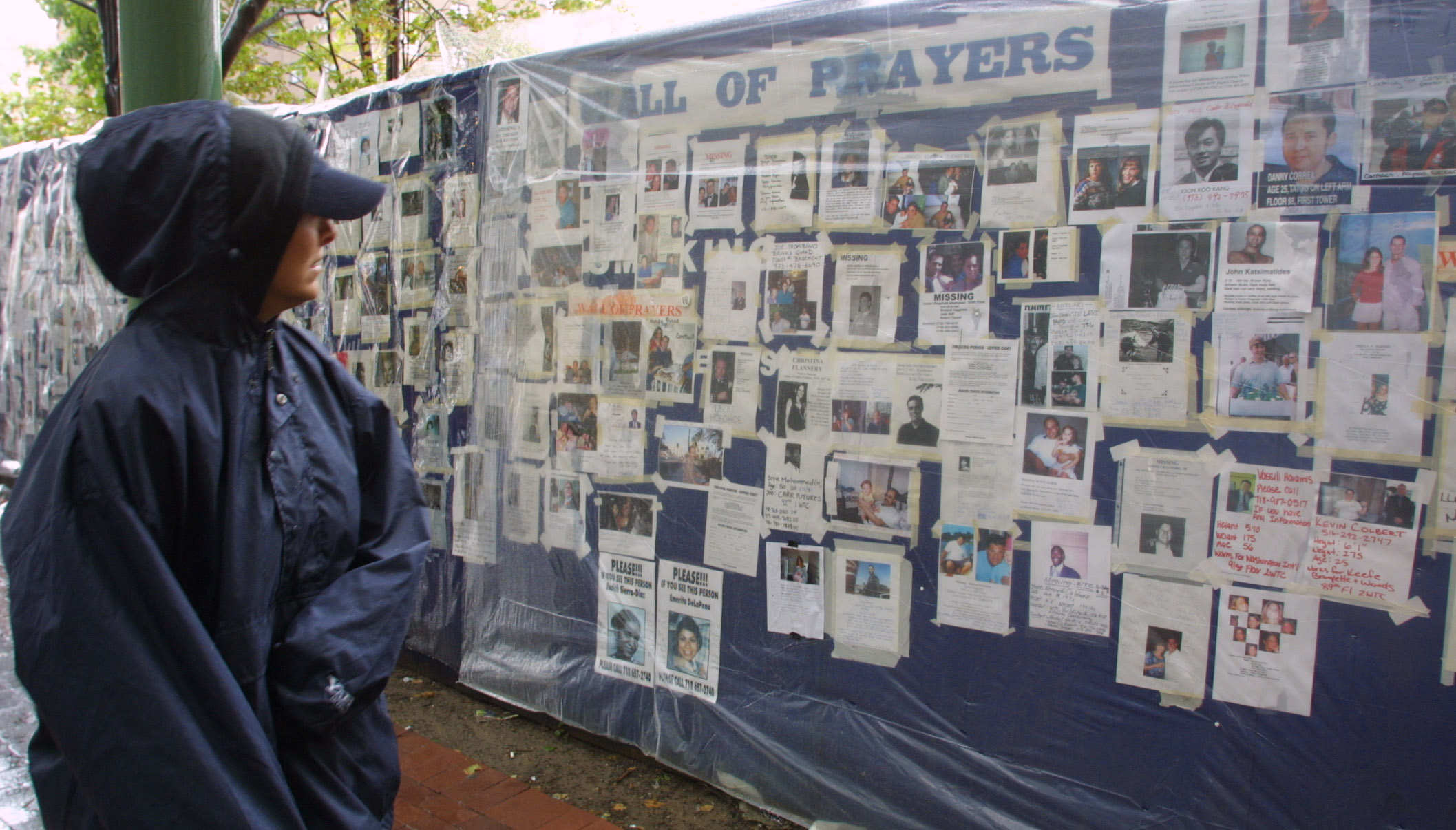 A woman looks at missing person posters of victims of the September 11 terrorist attacks.
