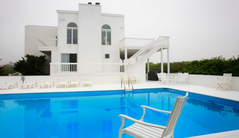 In this May 15, 2009 file photo, an ocean-side beach house with a swimming pool is shown in Wainscott, N.Y.