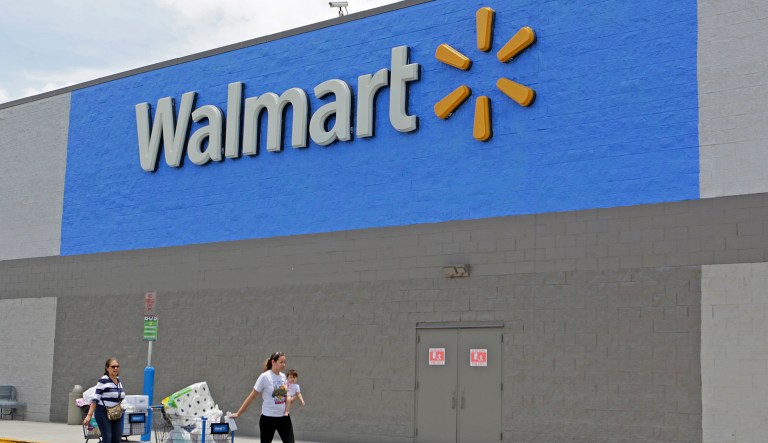 Customers walk out of a Walmart store in Hialeah Gardens, Fla. 