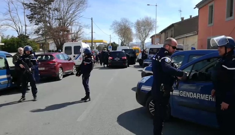 Police attend an incident in Trebes, southern France, Friday. French counterterrorism prosecutors are taking charge of the investigation into the shooting of a police officer in southern France that has led to an apparent hostage-taking at a supermarket. 