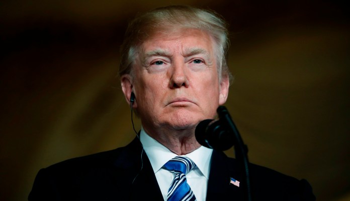 President Trump listens during a news conference in Palm Beach, Fla. 
