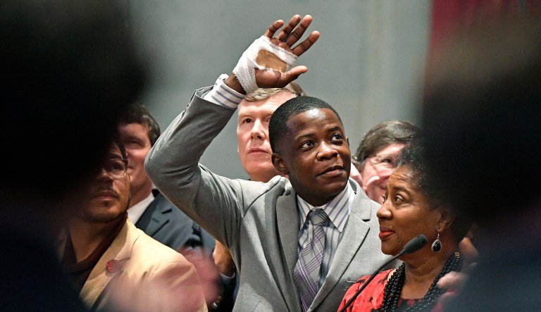 FILE - In this Tuesday, April 24, 2018, file photo, James Shaw Jr. waves to the crowd and legislators inside the Tennessee House chambers at the Tennessee State House in Nashville, Tenn., as he is honored for disarming a shooter inside an area Waffle House. The White House says President Donald Trump has spoken with 29-year-old James Shaw Jr., a Tennessee man who wrestled a rifle away from a gunman at a Nashville Waffle House. (Larry McCormack/The Tennessean via AP, File)