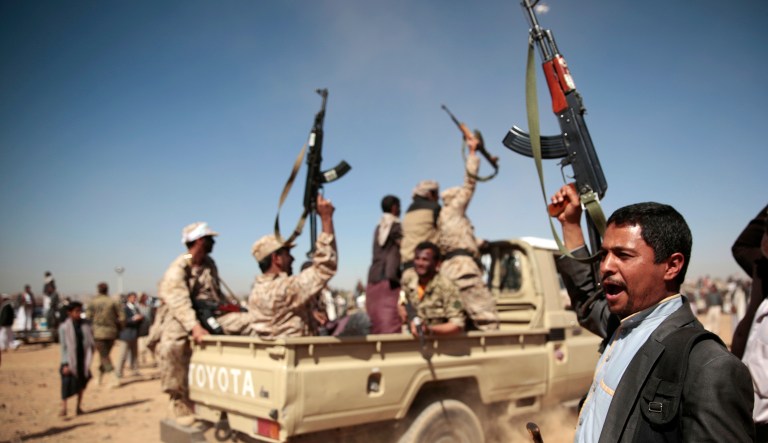 A tribesman loyal to Yemen's Shiite Houthi rebels, right, chants slogans during a gathering aimed at mobilizing more fighters into battlefronts to fight pro-government forces in several Yemeni cities.